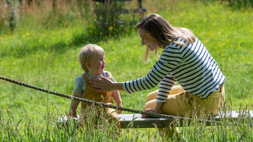 Mother and son in a grassy meadow